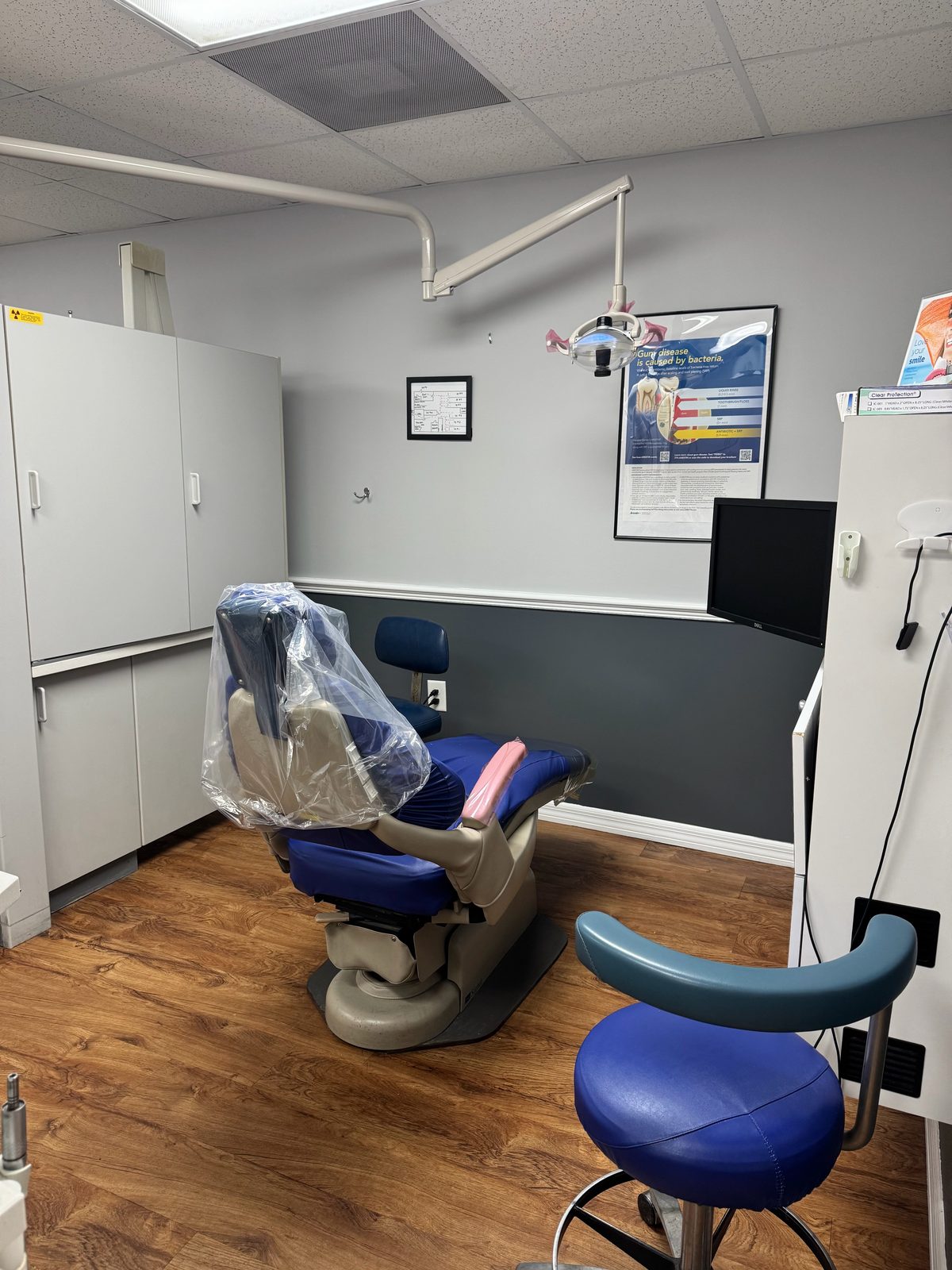 Treatment room at Dental Day in Brandon, FL, with a dental chair, overhead light and monitor