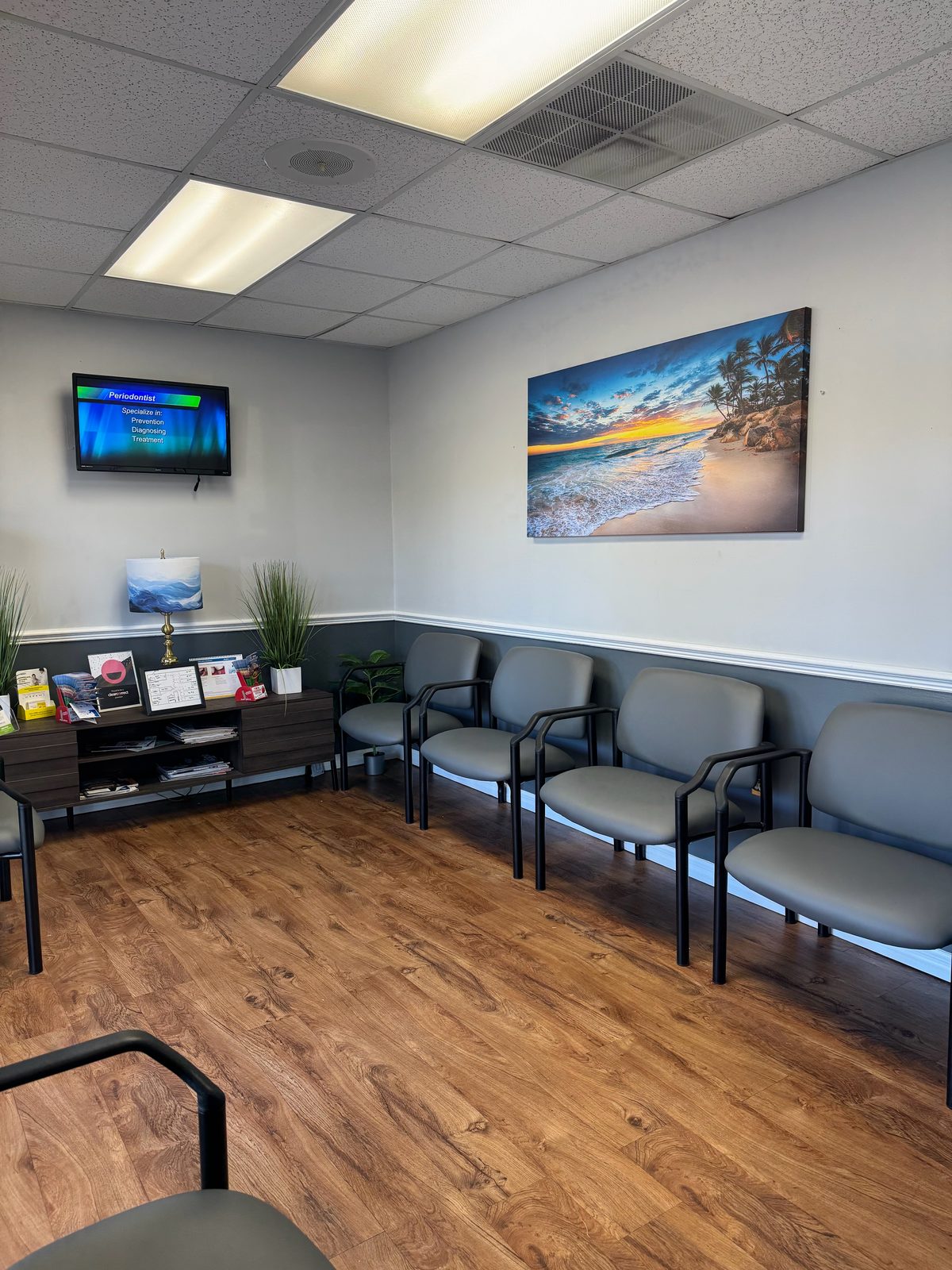 Dental Day waiting room in Brandon, FL, with gray chairs and a beach painting